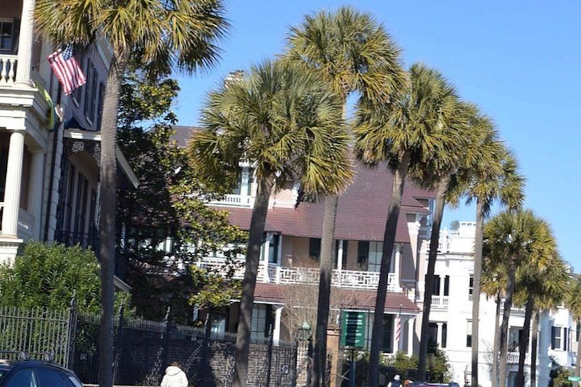 A building with a red roof, palm trees, and an American flag. 3