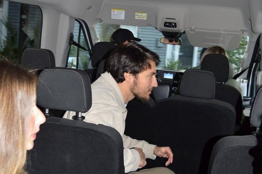 A vehicle interior with multiple seats and a dashboard. 4