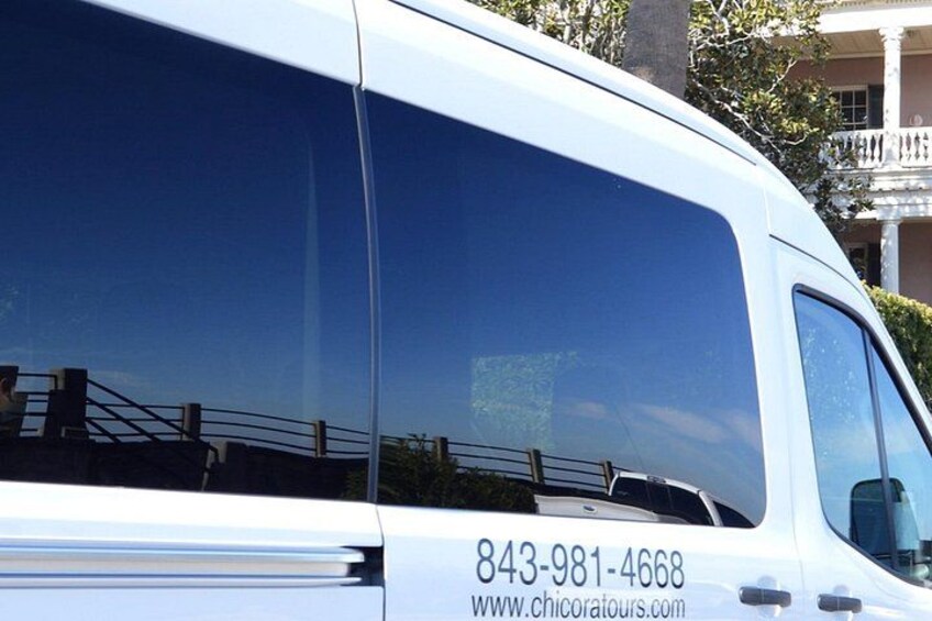 A white van with a contact number and website on the side. 5