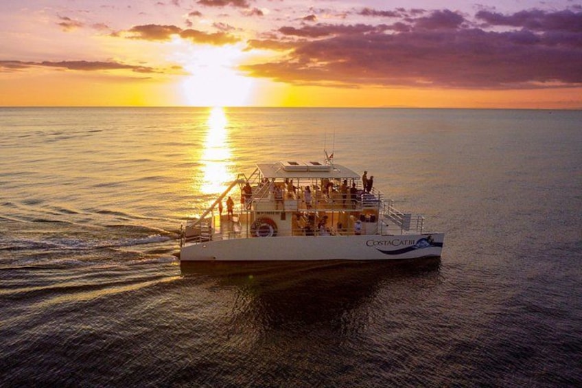 A boat named 'CostaCathie' on calm waters during sunset. 5