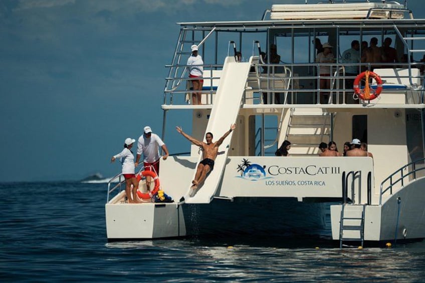 A boat with people on deck, a lifebuoy, and the text 'CostaCat III Los Suenos, Costa Rica'. 2