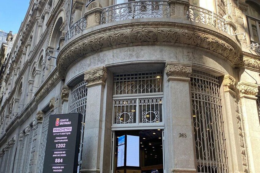 A historic building with ornate architectural details, including a large arched entrance and decorative metalwork. 4