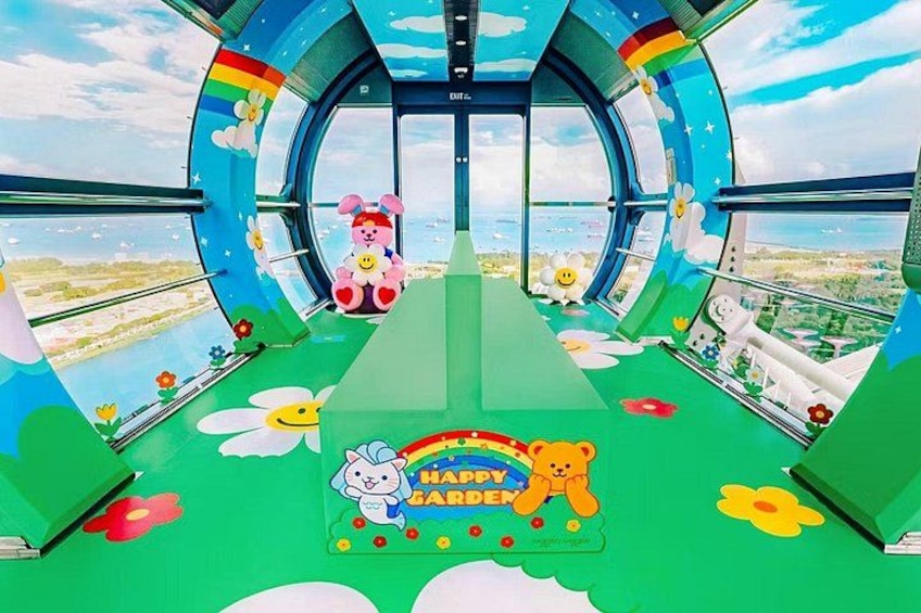 A colorful children's play area with a green floor, a bear, a bunny, and a rainbow sign. 2