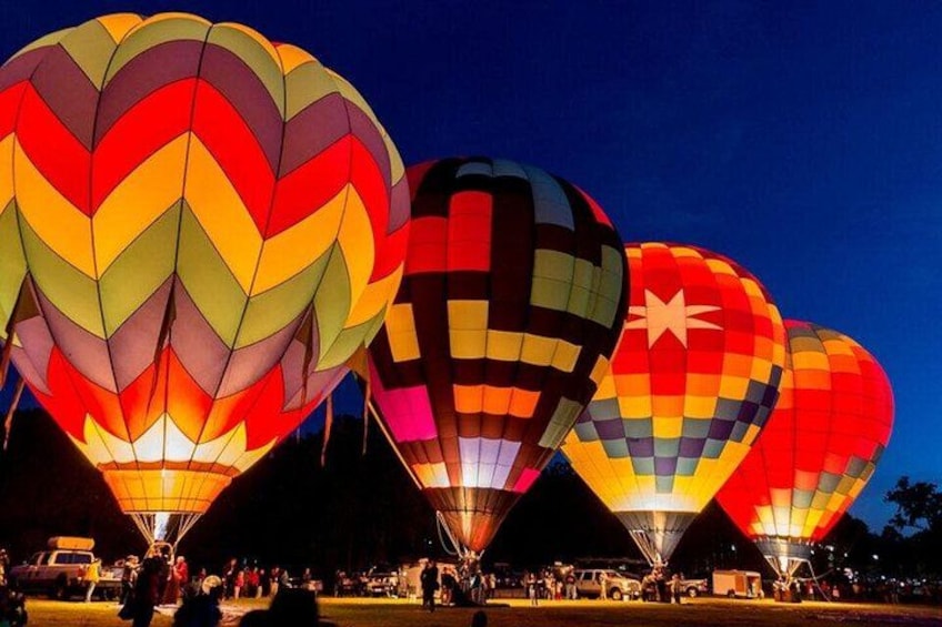 A line of colorful hot air balloons at night. 2