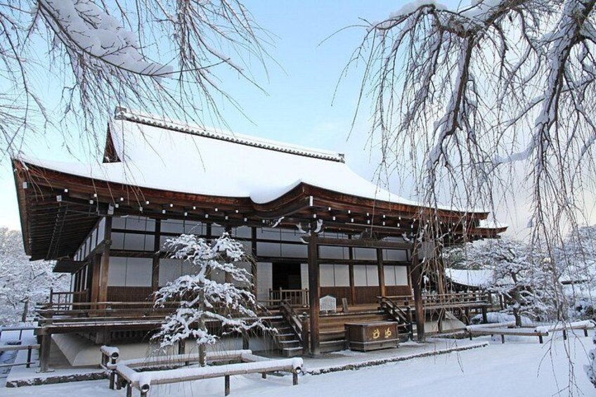 A traditional Japanese building with a snow-covered roof and wooden structure. 3