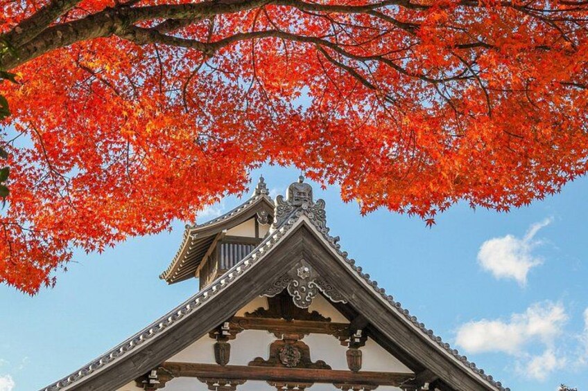 A traditional Japanese building with a tiled roof and ornate decorations. 4