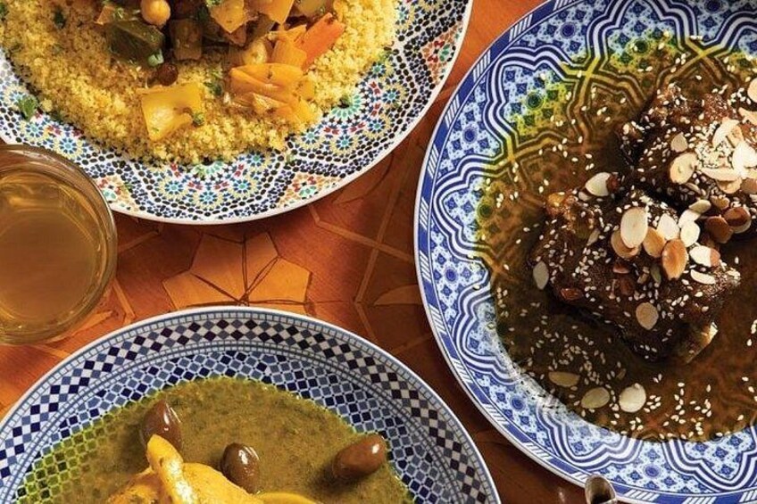 Three plates of food with a patterned tablecloth. 1