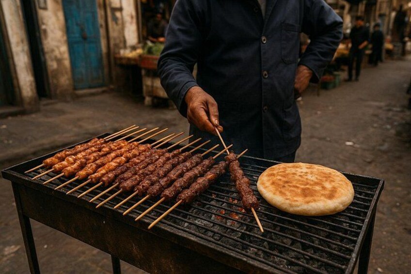 A person grilling skewers and a flatbread on an outdoor grill. 2