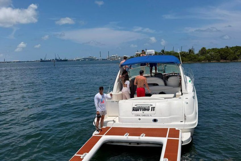 A boat named 'RUFFING IT' with people boarding and disembarking. 2