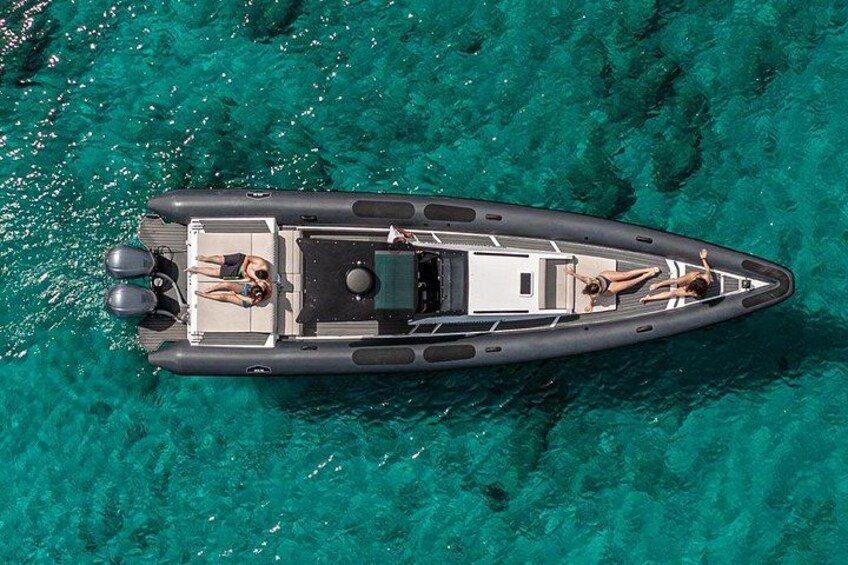 A small inflatable boat on clear turquoise water. 2