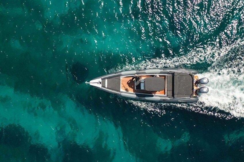 A small motorboat on a turquoise sea. 4