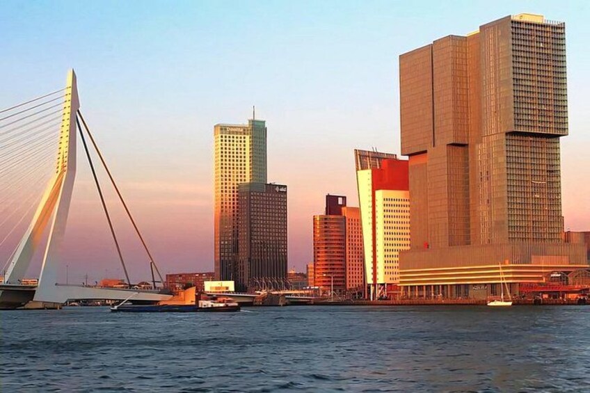 A modern city skyline with a prominent cable-stayed bridge and several high-rise buildings. 4