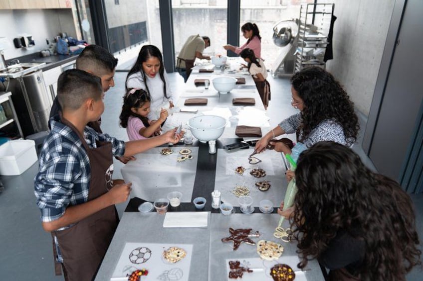Un grupo de personas participa en una actividad de cocina alrededor de una mesa con tazones e ingredientes. 2