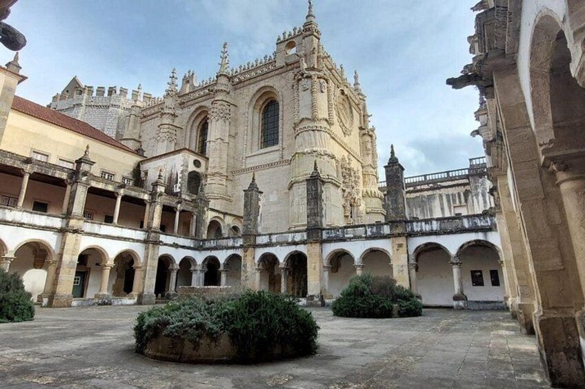A historic building with ornate architecture, a courtyard with arches, and a fountain. 4