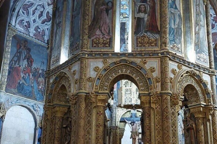 An ornate architectural structure with intricate carvings and a detailed ceiling fresco. 2