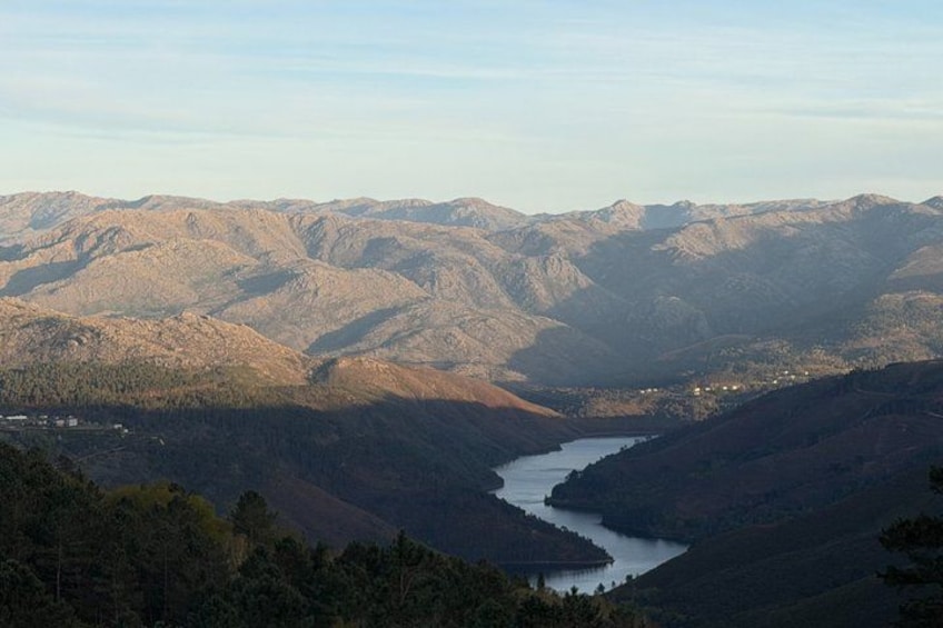 A mountainous landscape with a river winding through a valley. 4