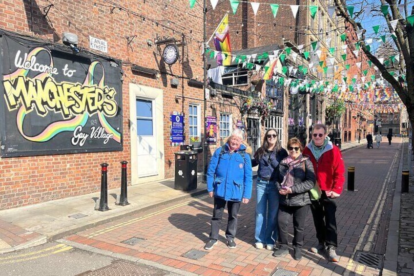 A brick building with a sign reading "Welcome to Manchester's Gay Village." 1
