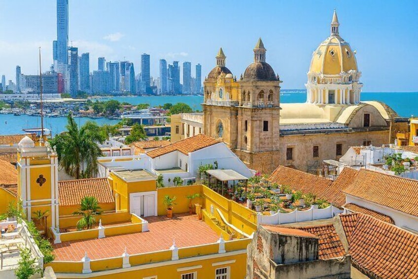 A coastal cityscape with historic buildings, a prominent church, and a modern skyline. 5