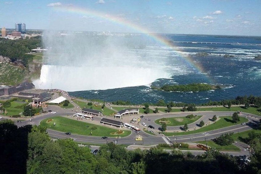 A waterfall, a bridge, and a road with vehicles. 1
