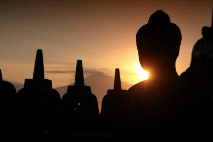 A silhouette of a person with a sunset in the background. 1