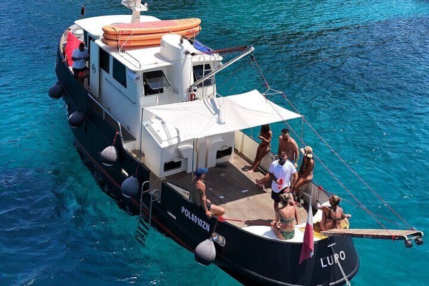 A boat named "LURO" with people on deck and a lifebuoy on the side. 3