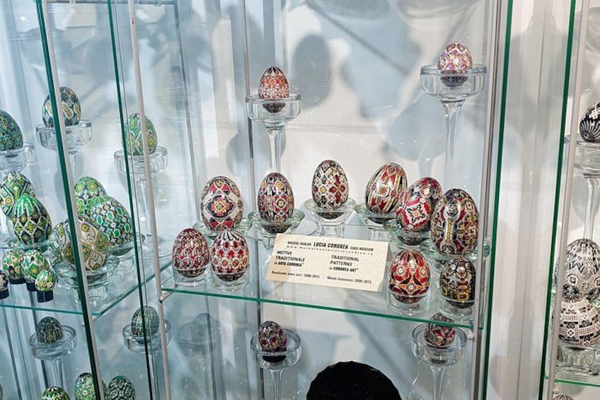 A display of intricately decorated eggs in a museum. 3