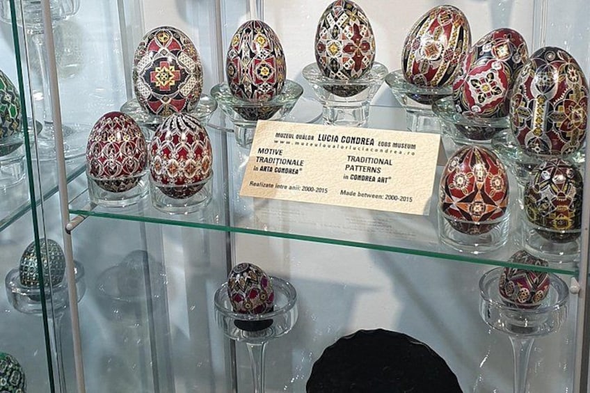 A display of intricately decorated eggs in a museum. 2