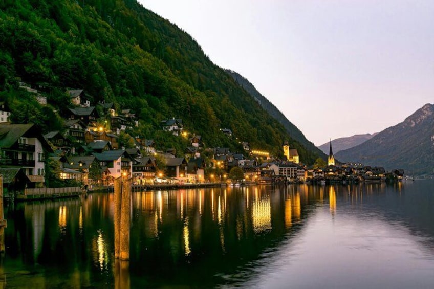 A lakeside village with houses, a church, and a mountain backdrop. 1
