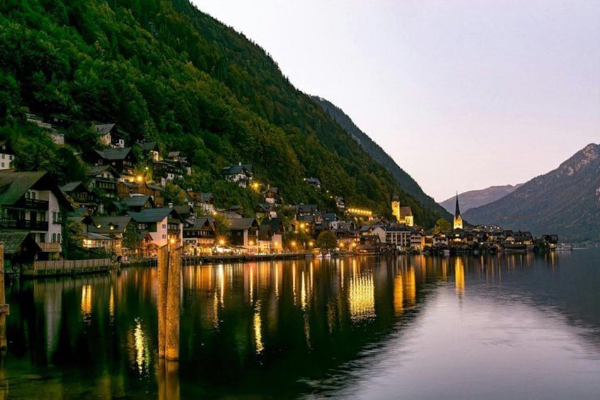 A lakeside village with houses, a church, and a mountain in the background. 1