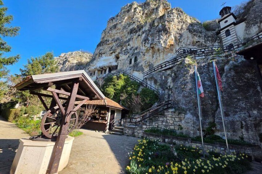 A mountain with a wooden structure, a staircase, and flags. 3