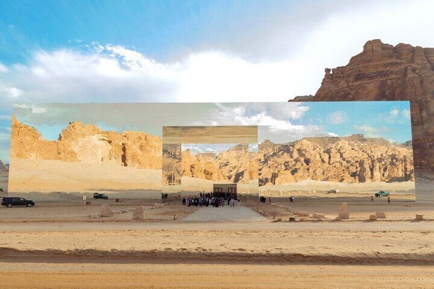 A desert landscape with rocky formations and a group of people gathered in the center. 3