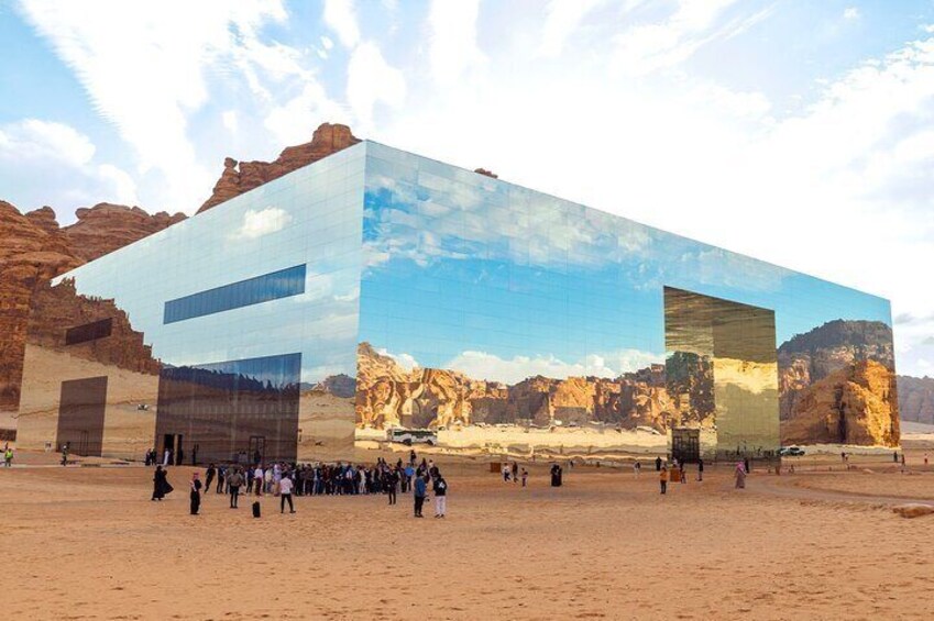 A modern building with desert rock formations in the background. 5