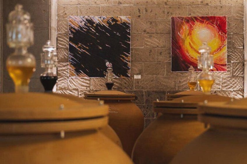 Wine barrels, a brick wall, and abstract paintings. 1