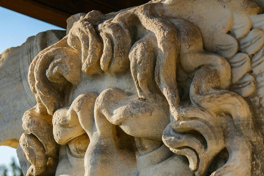 A close-up of a stone carving with intricate, swirling patterns. 3