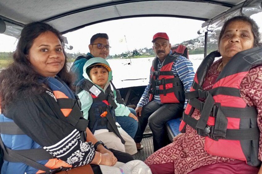 A group of people in a vehicle with life jackets, indicating a boating activity. 5