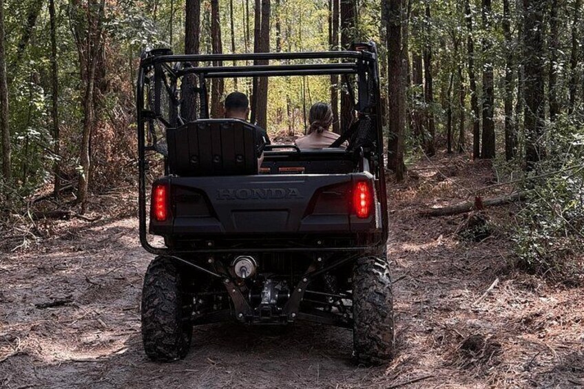 A Honda ATV in a forested area. 4