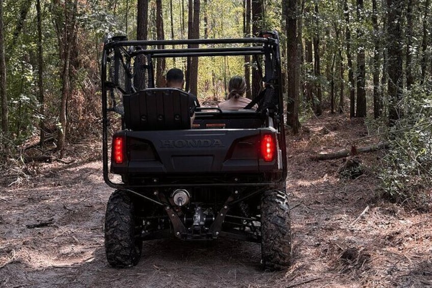 A black Honda ATV in a forest. 5