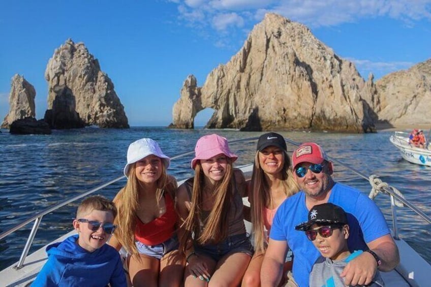 A family on a boat with rocky formations in the background. 5