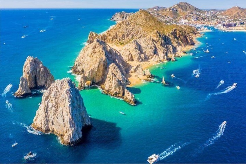 A coastal landscape with rocky formations and clear blue waters. 1