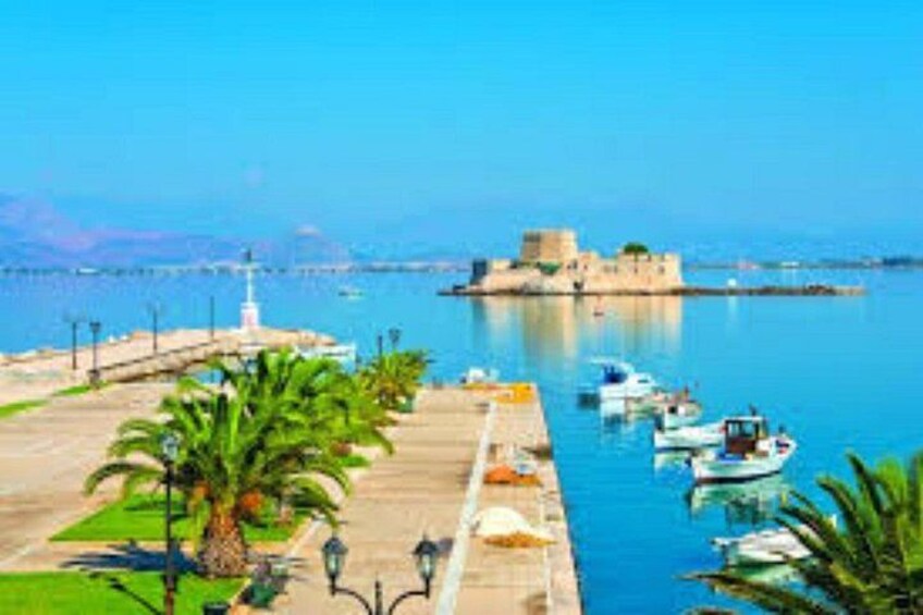 A coastal scene with a fortified structure, a marina with boats, and a promenade with palm trees. 3