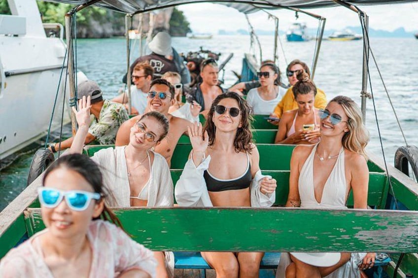 A group of people on a green boat on water. 4