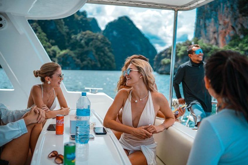 A group of people on a boat with a mountainous landscape in the background. 5
