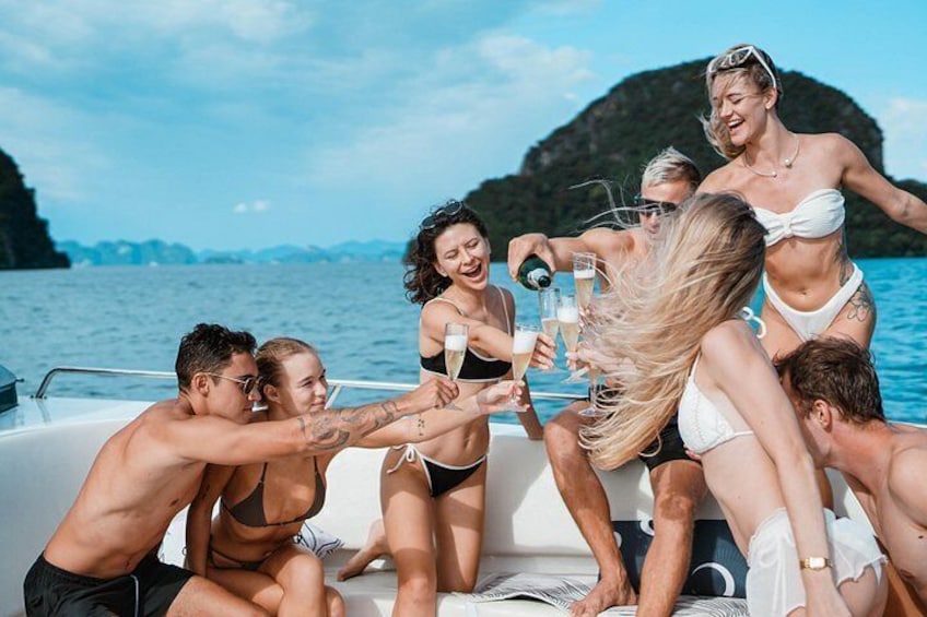 A group of people on a boat, toasting with champagne glasses. 4