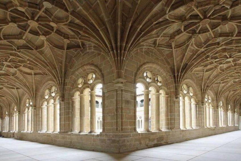 A cathedral interior with arched ceilings, columns, and large windows. 1