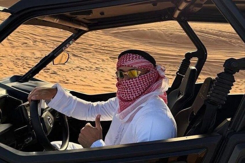 A person driving a vehicle in a desert landscape. 5