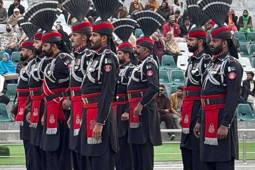 A group of uniformed personnel in ceremonial attire standing in formation. 4