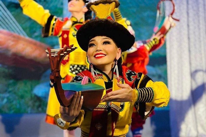 A person in a colorful costume with a large hat, holding a prop. 3