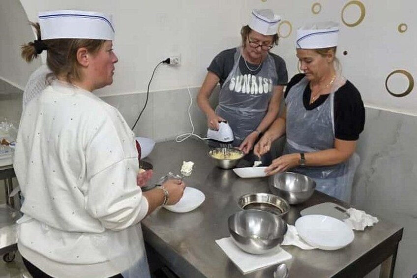 Tre personer i et køkken laver mad. 5