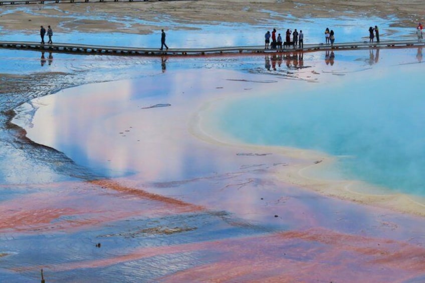 A large, colorful mineral pool with people walking around it. 3