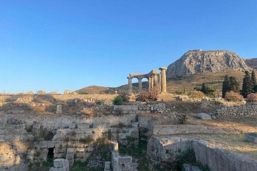 Ancient ruins with columns and a mountain in the background. 5